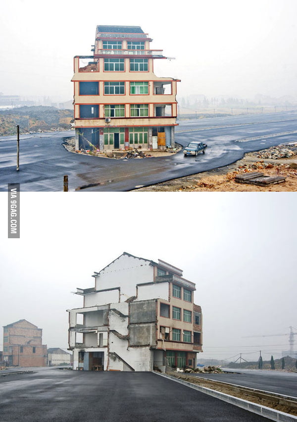 Homeowners refuse to relocate for the road. Zhejiang, China.