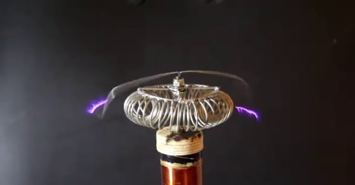 Tesla coil wirelessly illuminating a light bulb - 9GAG