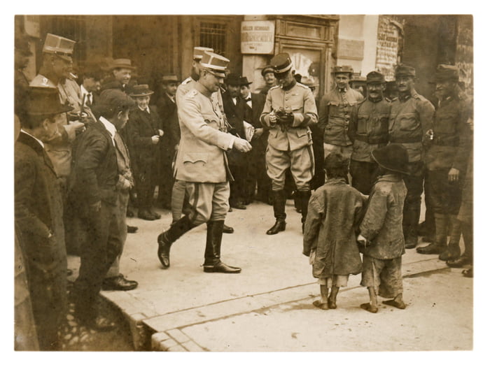 Two Young Rag Wearing Child Beggars Surrounded By Group Of Austro Hungarian Officers And Soldiers Begging For Money Town In Maramureș Region Somewhere In What Is Now Western Ukraine During Ww1 Exact Date