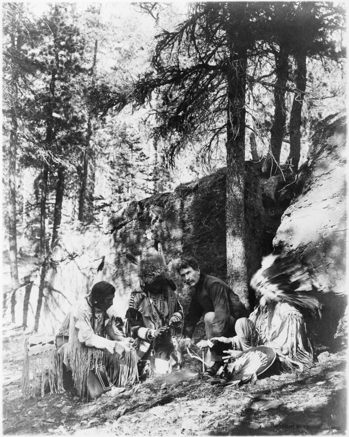 Three members from Blackfeet tribe teaching Ernest Thompson Seton how