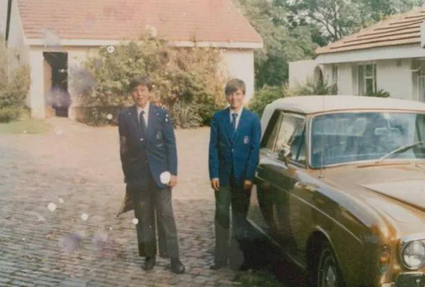 A young Elon Musk and his brother Kimbal Musk with their father's Rolls