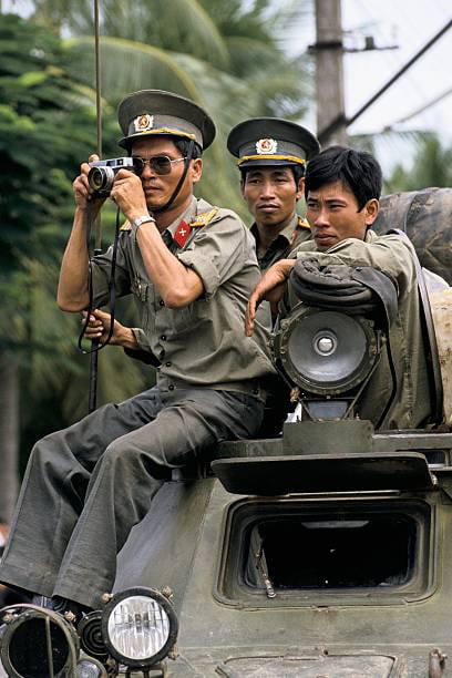 A Vietnamese army officer taking a picture with his camera during the ...