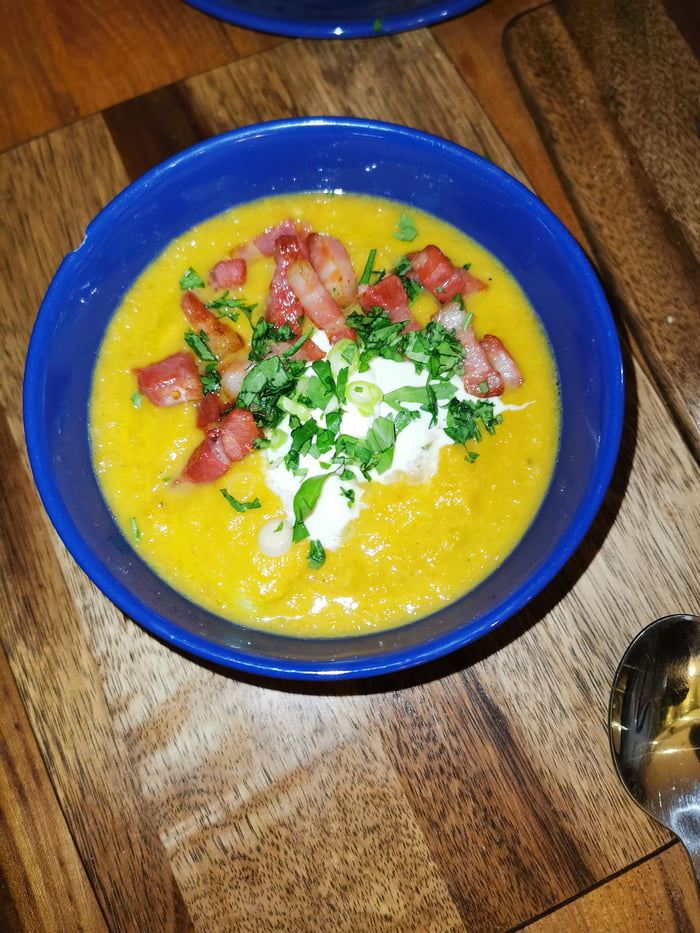 Leek and sweet potato soup, creme fraiche, lardons, spring onions and