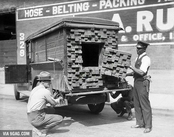 a-federal-agent-inspects-a-lumber-truck-after-smelling-alcohol-during