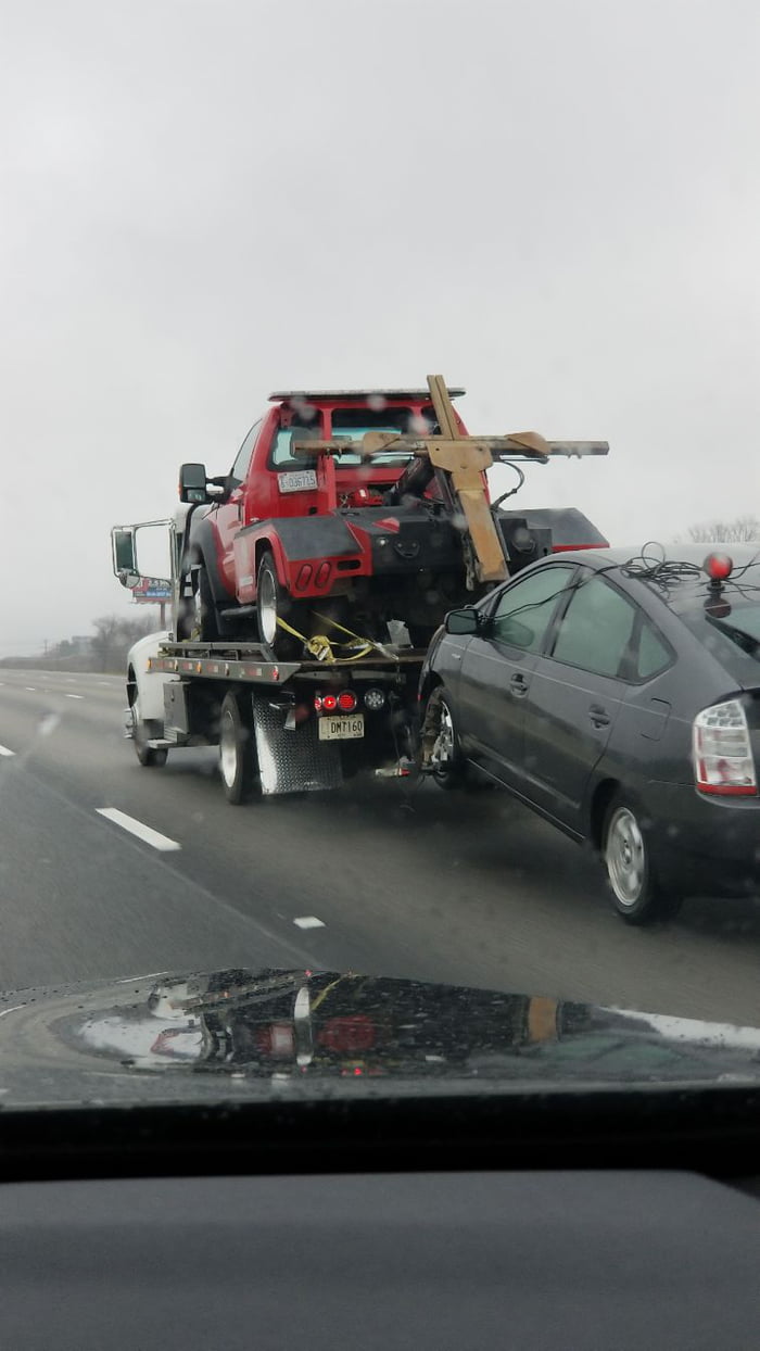 A Car Being Towed By A Tow Truck That Is Being Towed By Another Tow ...