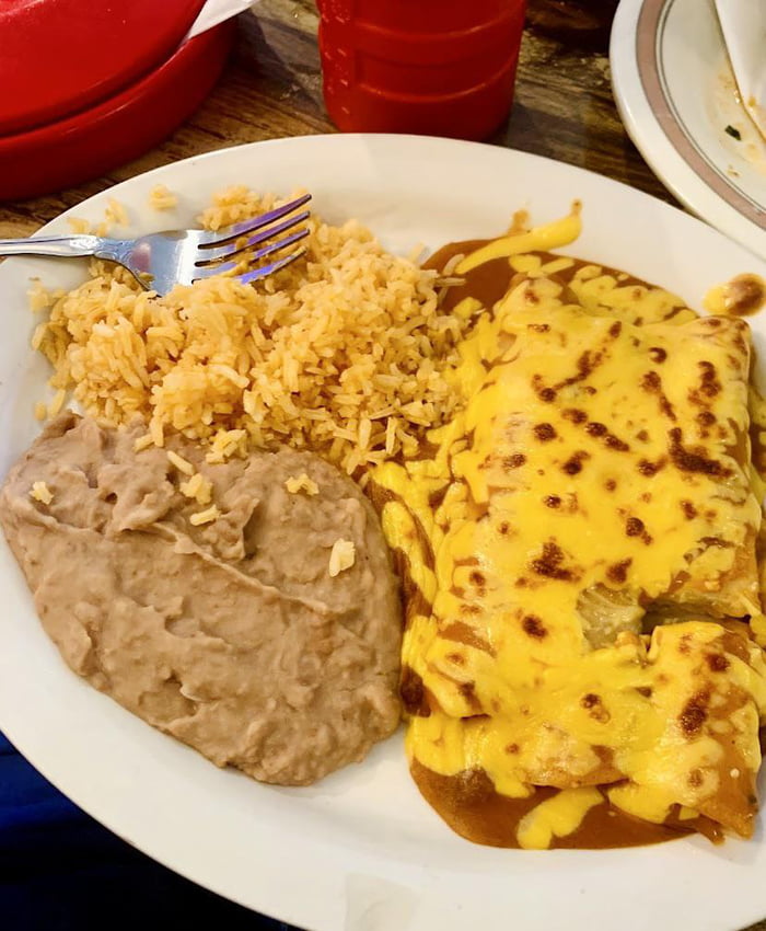 Enchiladas topped with shredded cheese, with rice & refried beans - 9GAG