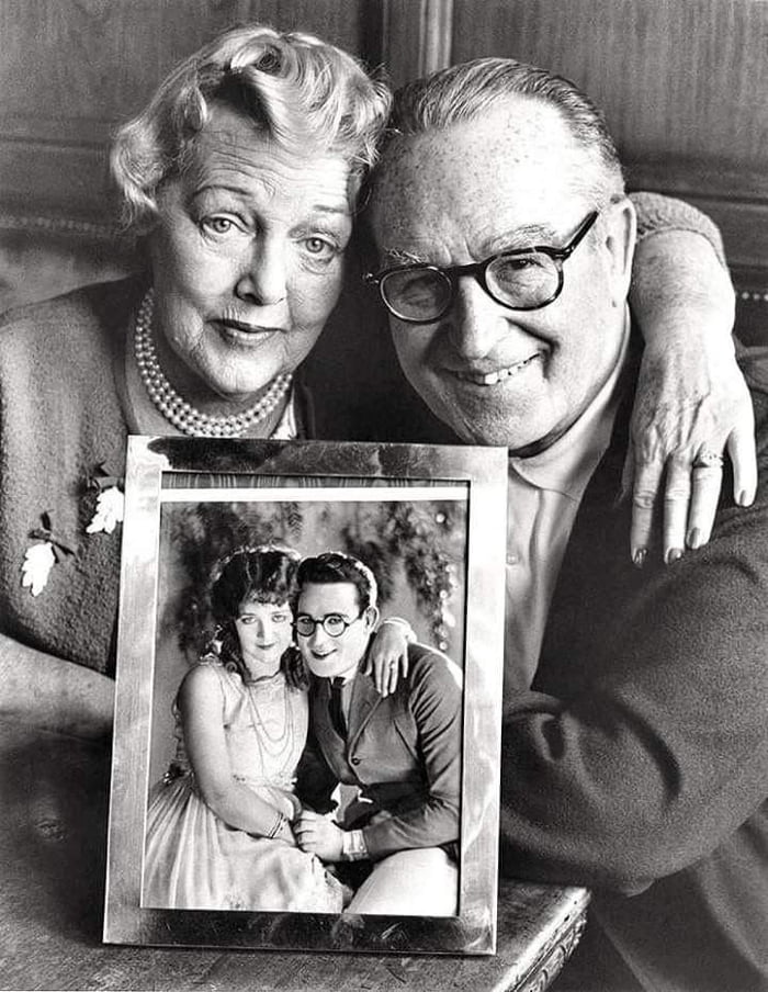 Harold Lloyd and Mildred Davis holding a photo of when they were young ...