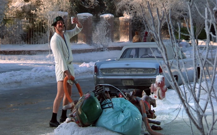 cousin-eddie-outside-in-his-bathrobe-emptying-out-the-good-old-rv-s