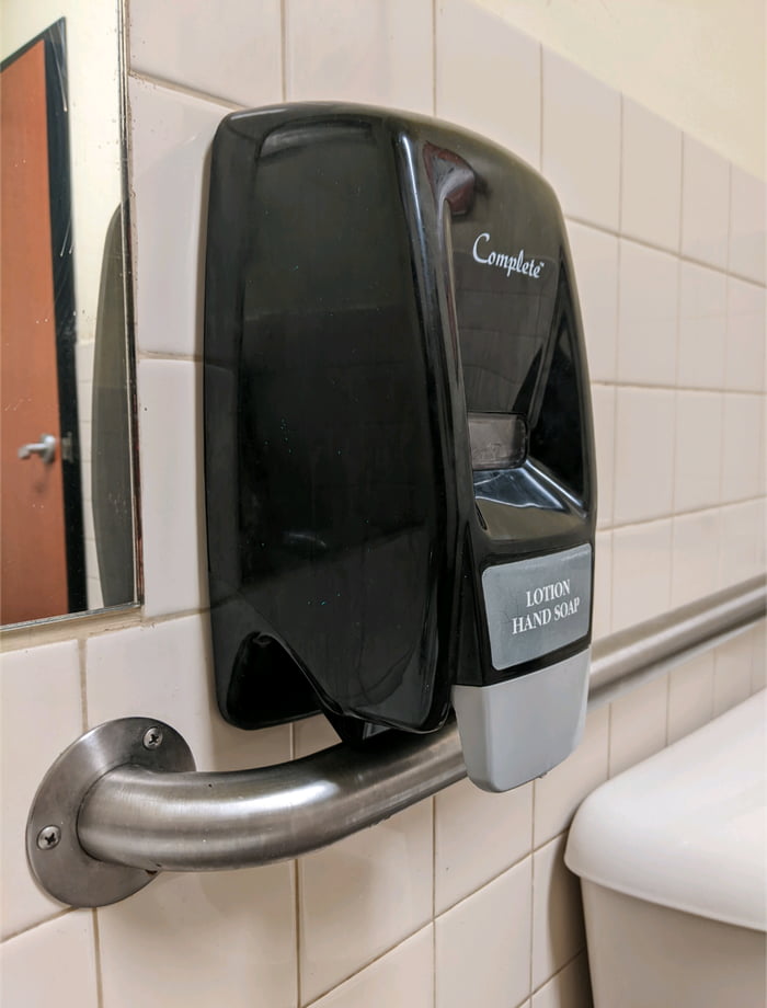 Whoever installed this soap dispenser in front of the hand rail which ...