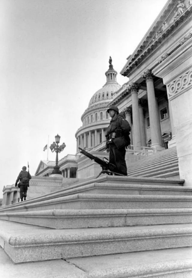 A soldier stands with his M60 machine gun on the steps of the U.S ...