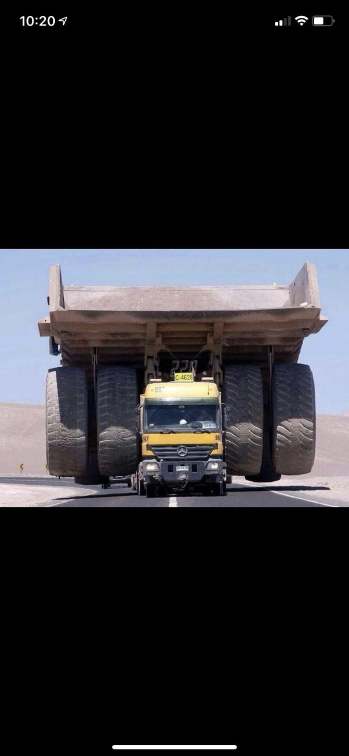 A Mercedes-Benz Actros truck hauling a Caterpillar 797 giant mining ...