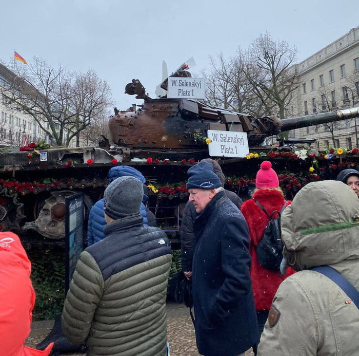 People Bring Flowers To The Damaged Tank Brought To Russian Embassy In ...