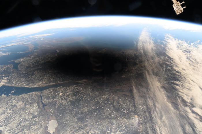 The Moon's shadow covers portions of Canada and the U.S. seen from ISS ...