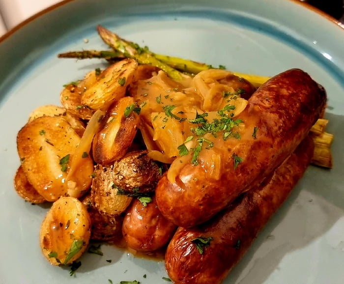 Marcus Wareing's sausages, crispy potatoes, grilled asparagus and onion