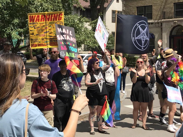 Group of satanists in front of one religious protester at Rochester ...