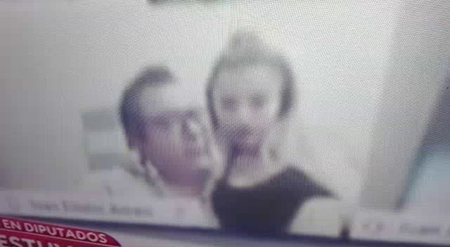 A congressman from Argentina sucking a tit during a congress session