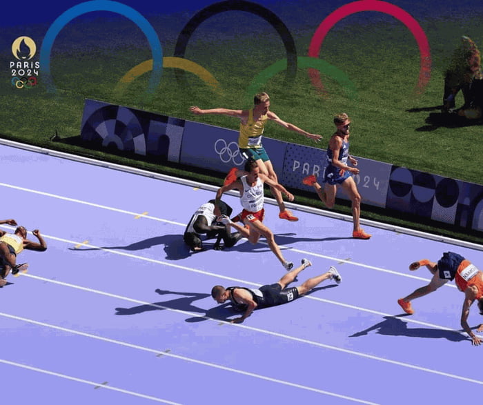 A mass fall of runners in the 5000 meter heats just metres from the ...