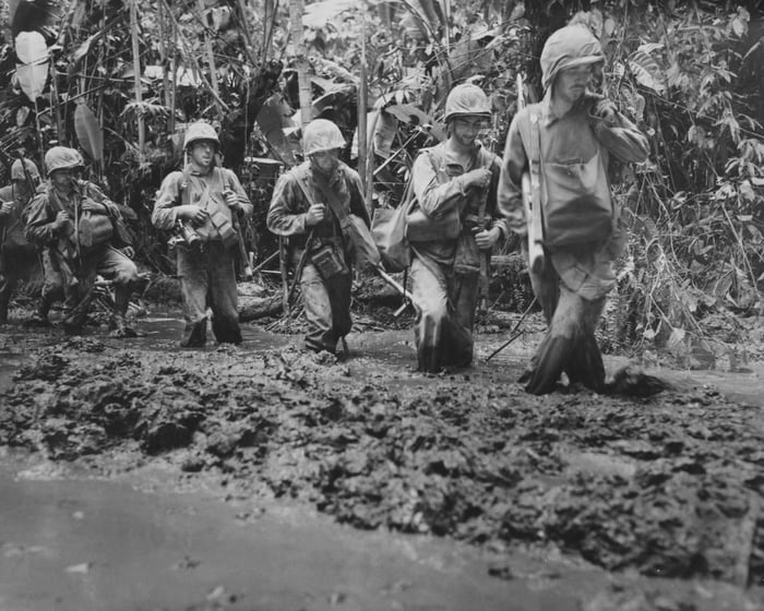 Marines trudge through mud on Bougainville, 1943 - 9GAG