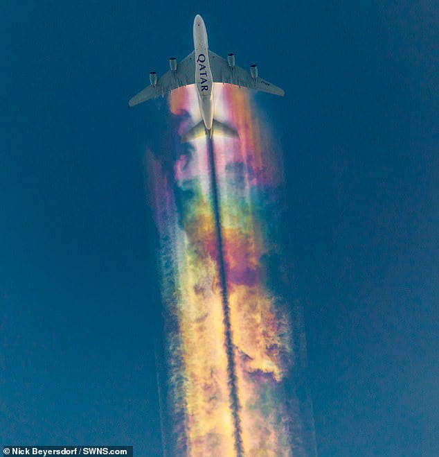 This amazing rainbow 'contrails' photo was captured by German photographer Nick Beyersdorf as it