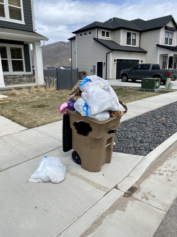 A note was posted on the back of the bin why neighbor’s trash didn’t
