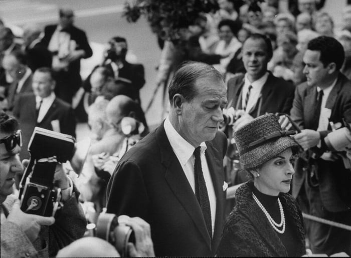 John wayne and wife arrived for the funeral service for actor gary