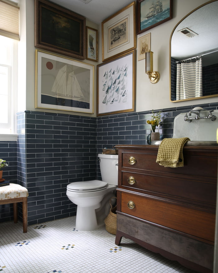 Nautical-themed bathroom renovation with blue subway tiles covering the ...