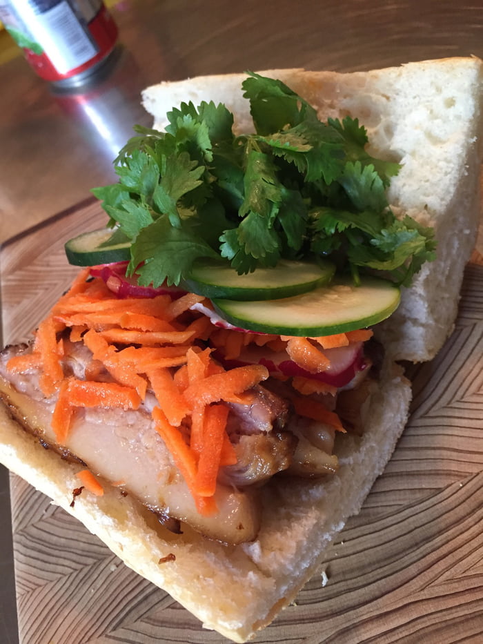 Banh mi with braised pork belly, pickled carrots, radish, cucumber and