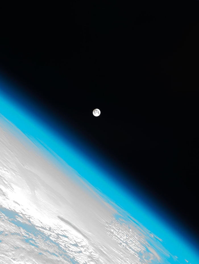 Photo of the Earths atmosphere and the moon. Shot by the international ...