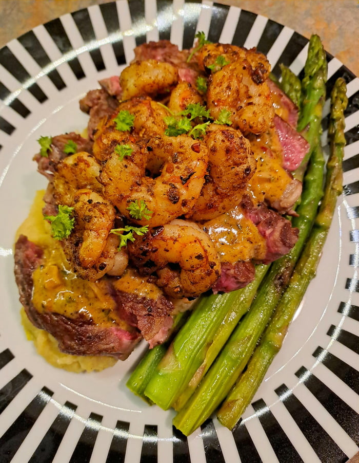 Surf and Turf (Rib-Eye Steak and Atlantic Prawns with sautéed asparagus ...