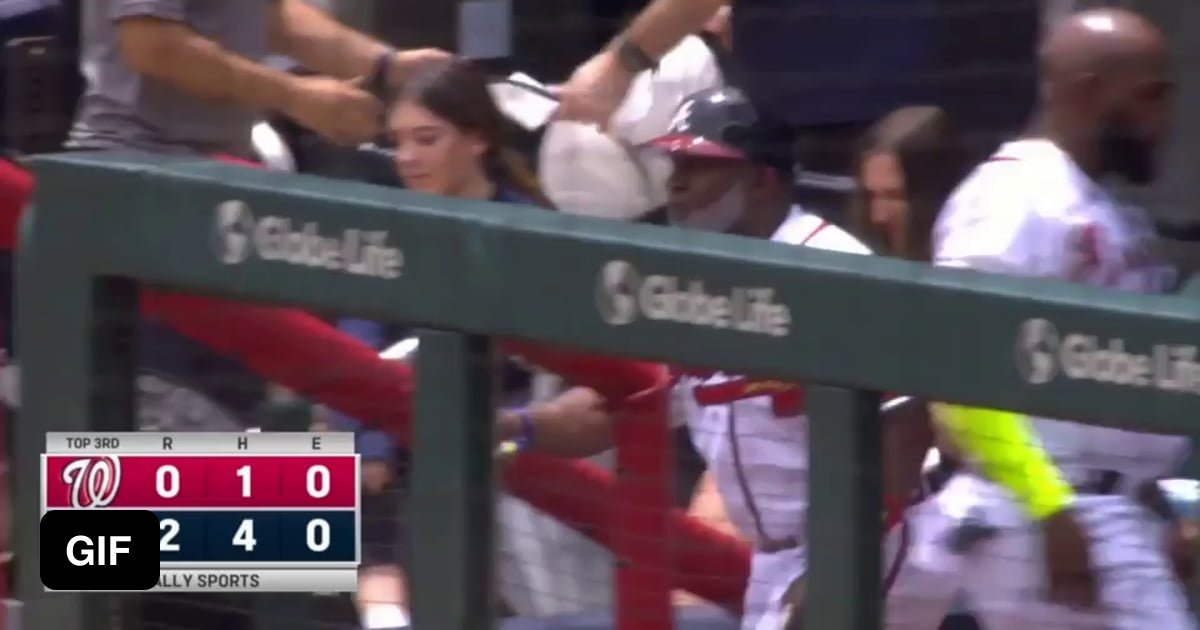 The Braves' first base coach, Eric Young Sr., makes sure the Nationals' first base coach, Eric