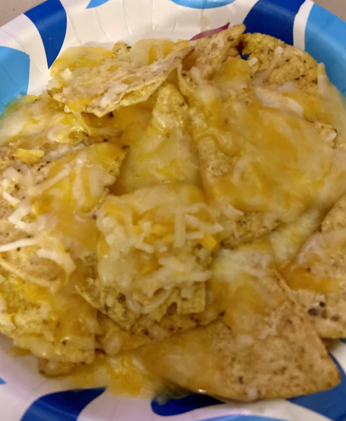 Midnight snack is microwaved tortilla chips with shredded Mexican