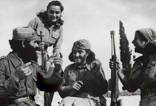 A Greek partisan of the communist-led People's Liberation Army (ELAS) chatting with three female comrades somewhere on the Greek mountains, 1944. - 9GAG