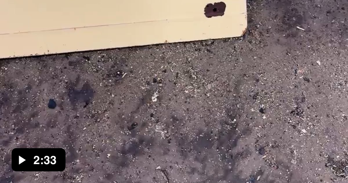 Pressure washing the paint off a tractor canopy after a chemical paint