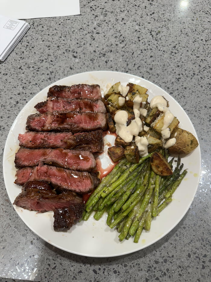 Boneless ribeye with rye whiskey reduction along with baked Parmesan asparagus and oven roasted