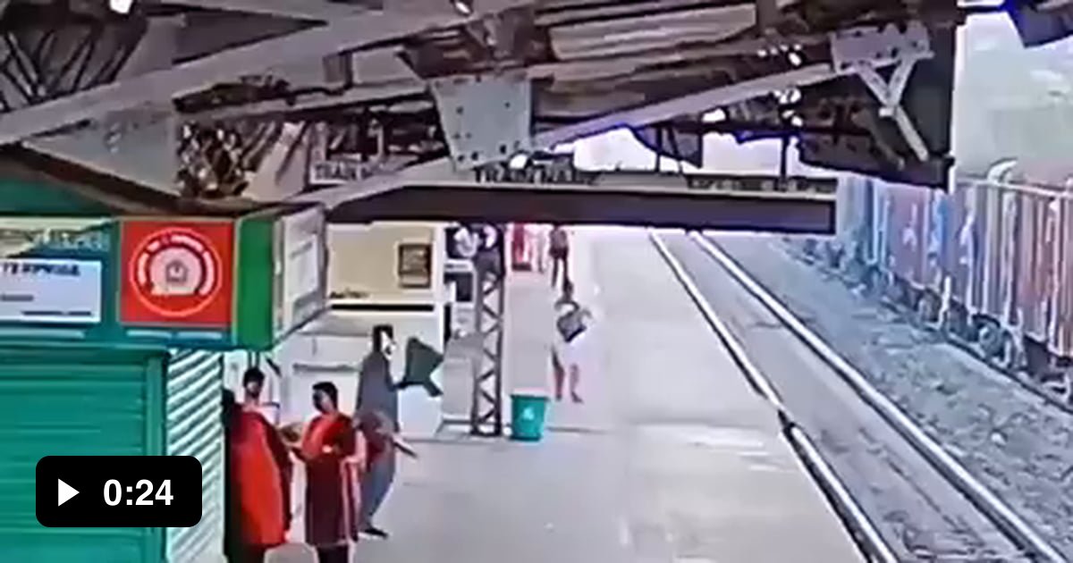 Man jumps on railway track to save a human life 9GAG