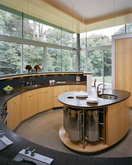 Curved Kitchen Island Cabinets In A Residence With Glass Walls On