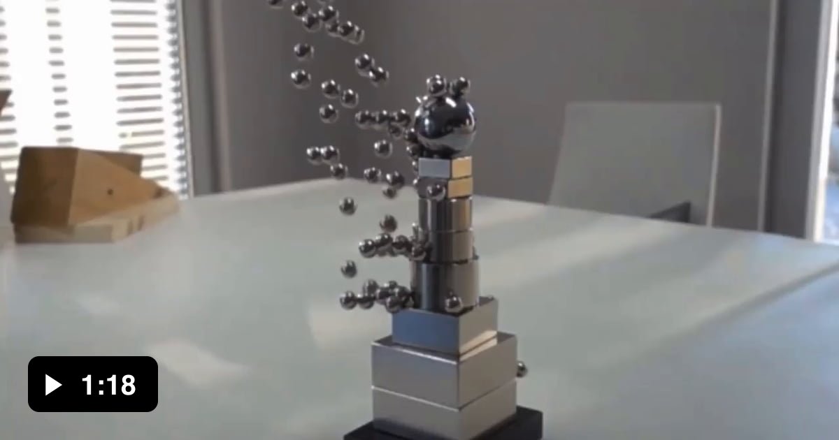 A tower of extremely dangerous and powerful neodymium and a cup of ball bearings 9GAG