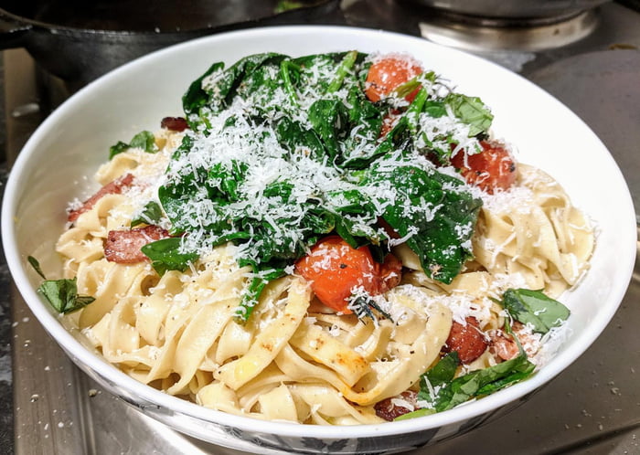 Fresh Egg Pasta With Bacon Tomatoes And Spinach Topped With Pecorino