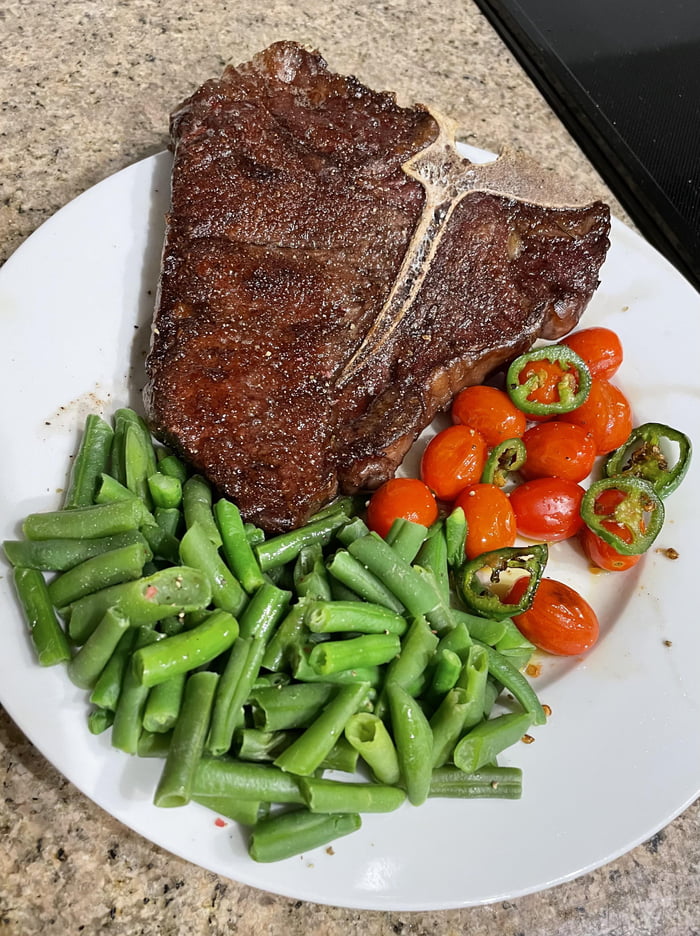 Tbone steak with buttered green beans and pan roasted tomatoes and