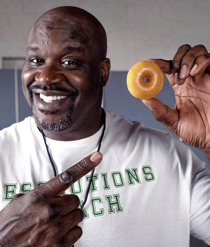 Shaq holding a full size donut - Awesome.