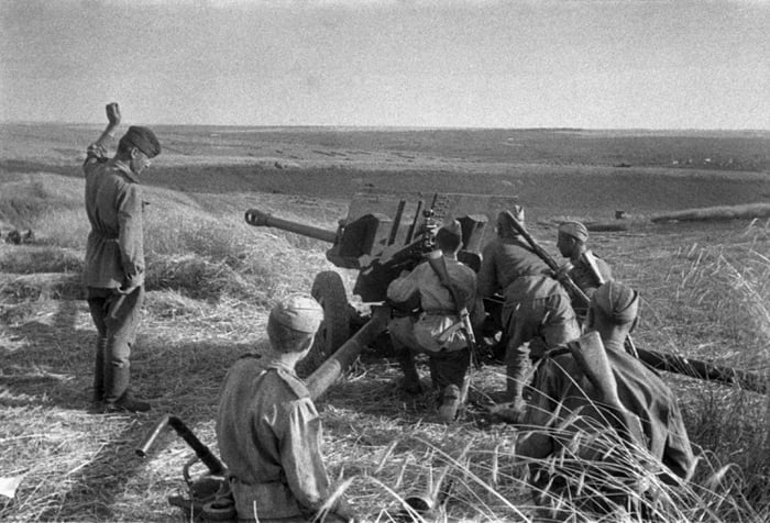 A Soviet Zis-3 AT gun fires at German forces during the Battle of Kursk ...