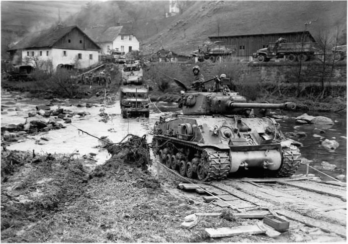 An M4 Sherman tank and other vehicles of the U.S. 11th Armored Division ...