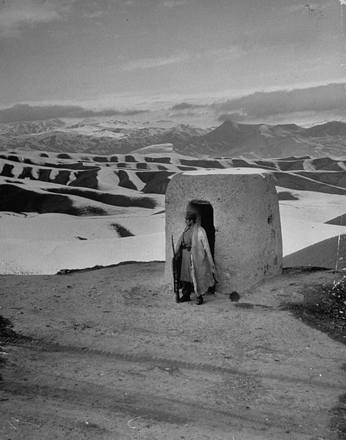 an-iranian-soldier-standing-guard-at-a-lookout-across-from-the-russian