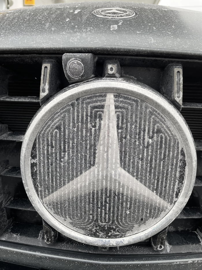 The heating coils in Mercedes emblem create a pattern after a snowstorm