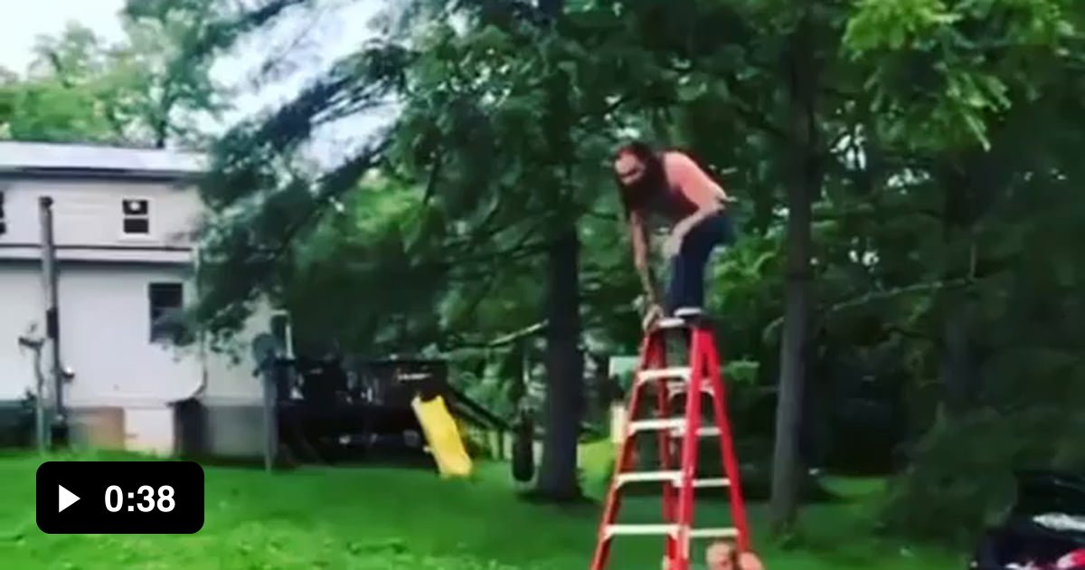 Shirtless Guy Jumps Off Step Ladder Onto Barbed Wire Trampoline And